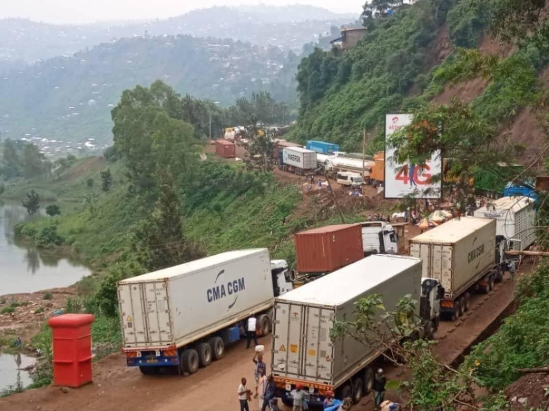 Container trucks on a hillside corridor road